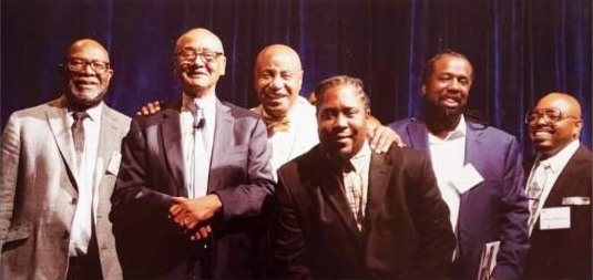 Darius Robinson standing with fellow community leaders
